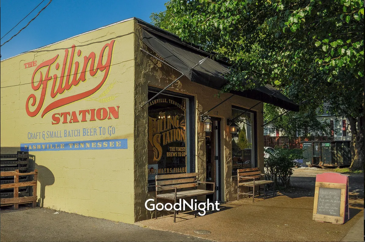 An inviting exterior image of The Filling Station, featuring its recognizable sign, outdoor seating, and window displays. The casual vibe and sunny atmosphere highlight a perfect spot for friends to gather and kick off their evening with local craft beers.