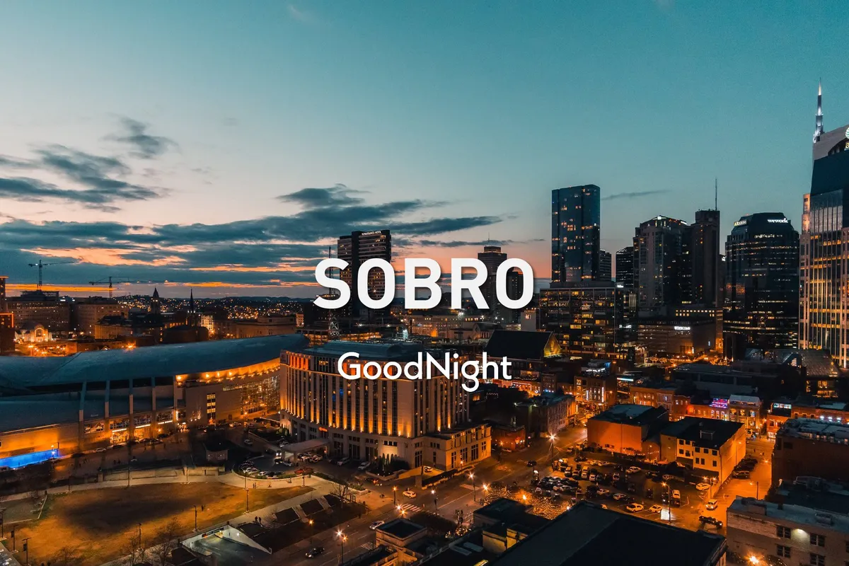 A sweeping city skyline glows with vibrant sunset colors, illuminating buildings and hinting at the city’s energetic nightlife. The elevated view provides a sense of adventure and excitement, ideal for couples looking to experience local dining and nightlife together.